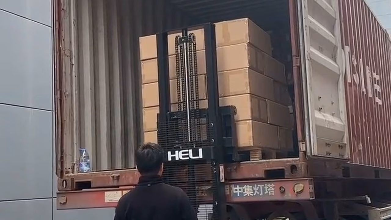 Packed boxes and pallet jack at a container door