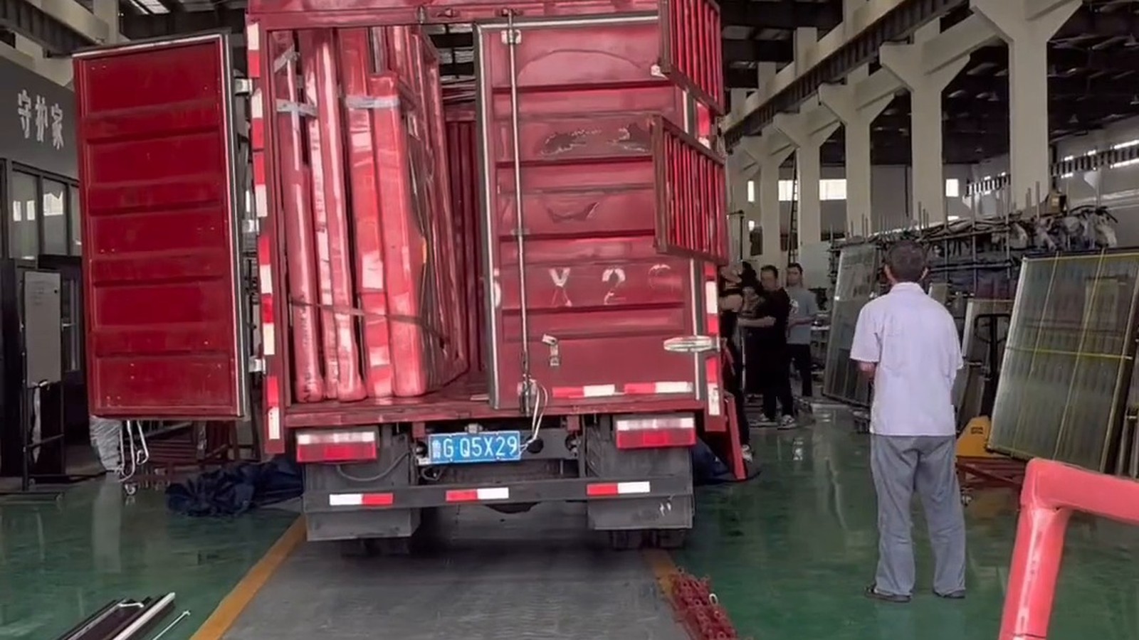Red truck in factory loading area during export preparation
